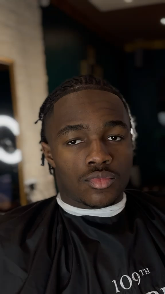 Vidéo verticale d'une finition de coupe homme au salon.